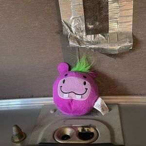 Smiling Purple Hippo Plush with Green Tuft